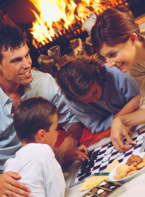 Family games by the wood-burning fireplace